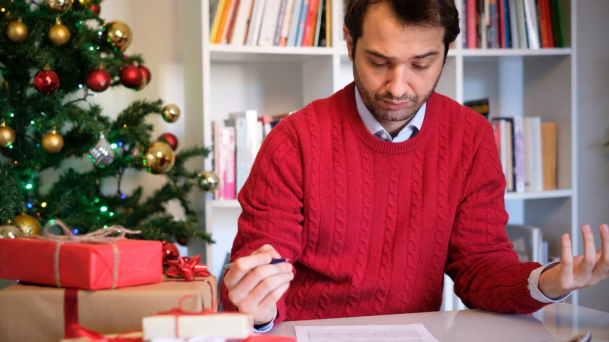 Man worried and with too many expenses for buying christmas present
