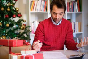 Man worried and with too many expenses for buying christmas present