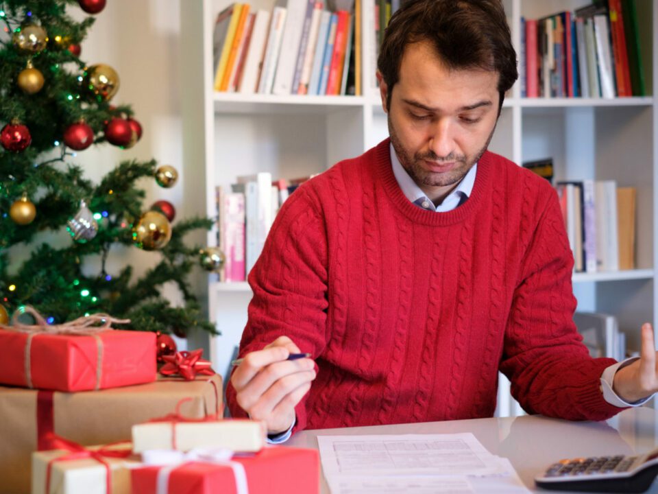 Man worried and with too many expenses for buying christmas present