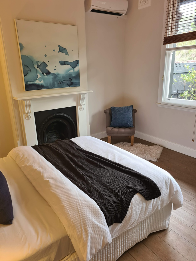 Restored period bedroom with fireplace in an Ashfield home, Inner West Sydney